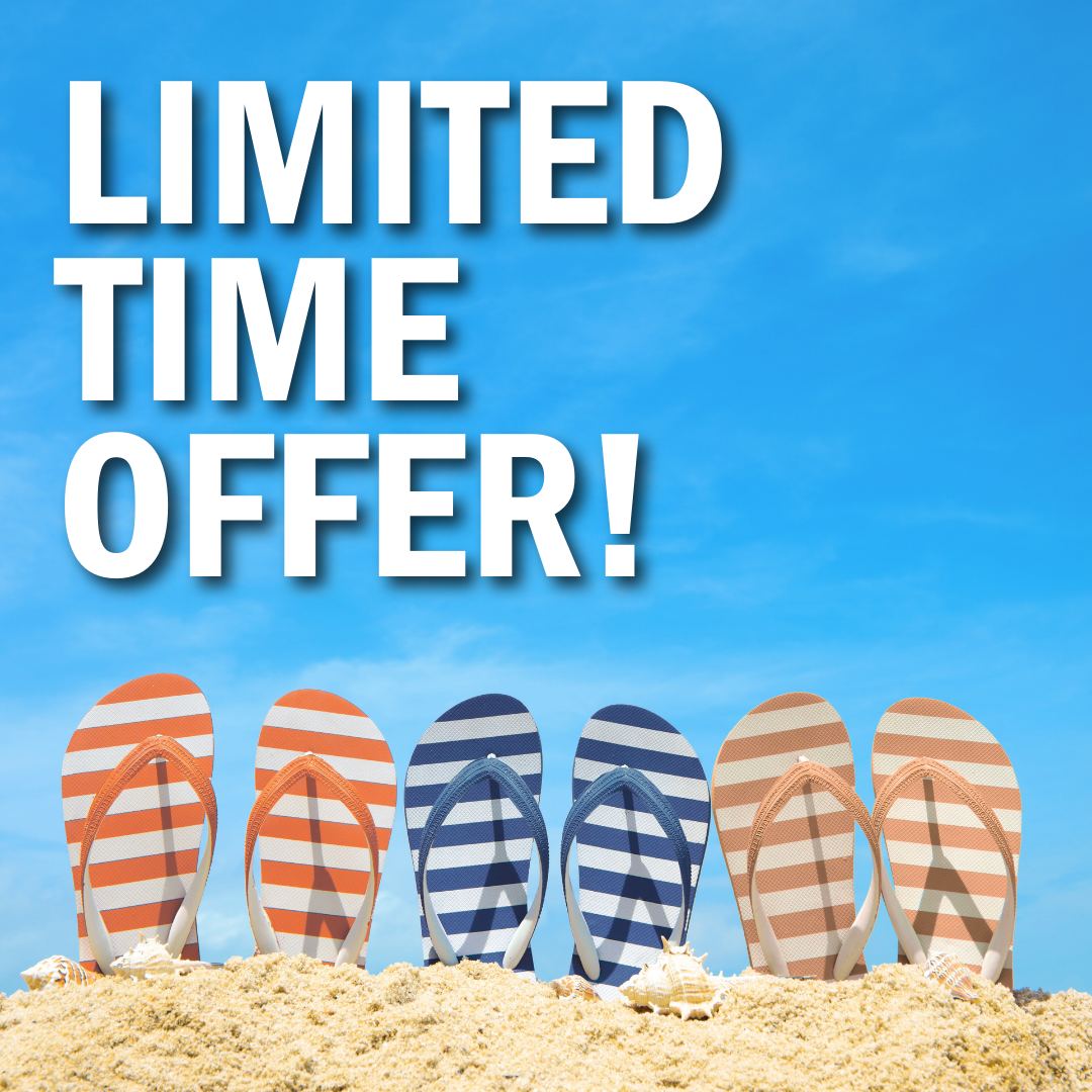 Three pairs of flip flops sitting in a pile of sand.