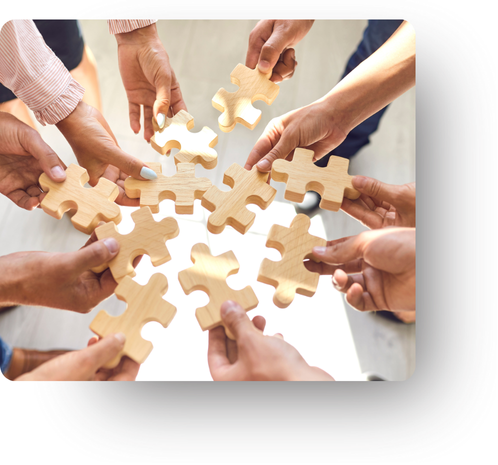 Group of people holding puzzle pieces together