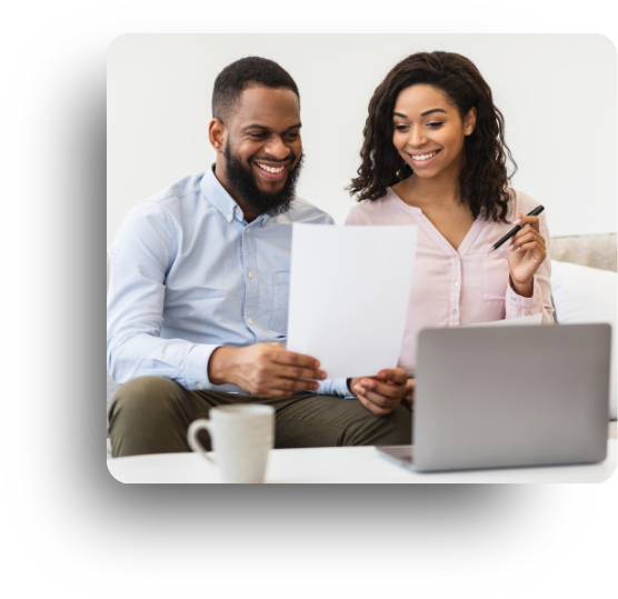 Happy couple looking a paper and laptop